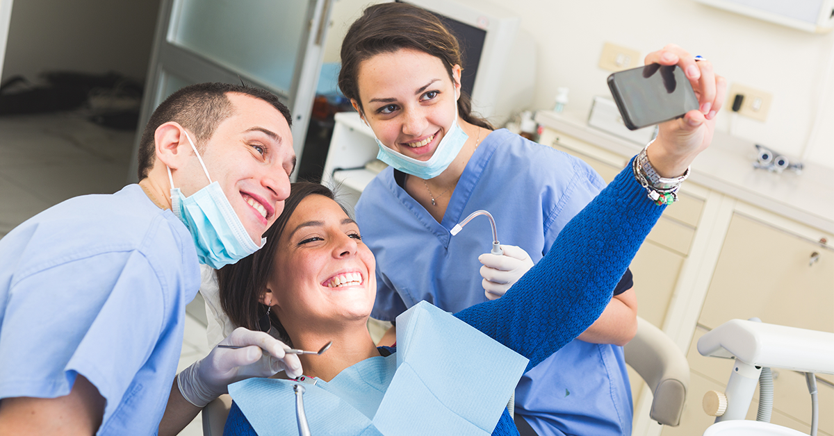 woman with caring dental professionals